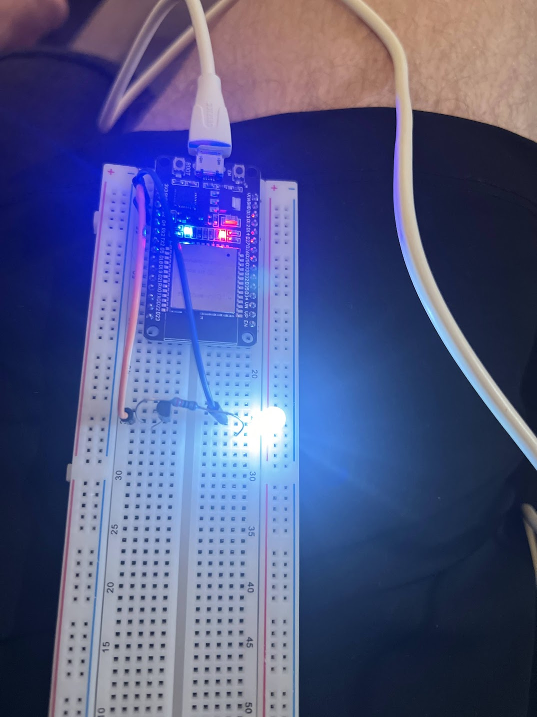 First circuit board with ESP32 and transistor that triggers an LED.